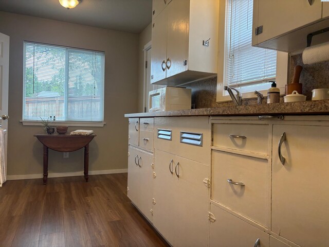 1320 NE Harvey Rd, Pullman, WA 99163 - kitchen featuring plenty of natural light, dark wood finished floors, baseboards, and white cabinetry