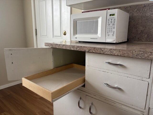 1320 NE Harvey Rd, Pullman, WA 99163 - kitchen view of white microwave, wood finished floors, and baseboards