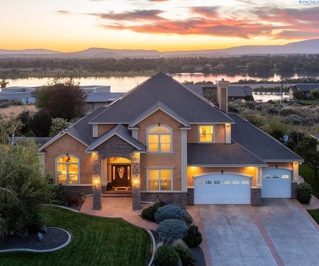 view of front of home featuring a garage and a water and mountain view