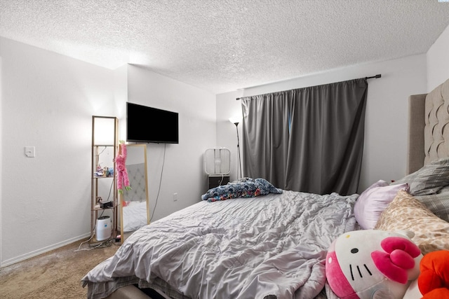 bedroom featuring a textured ceiling and carpet flooring