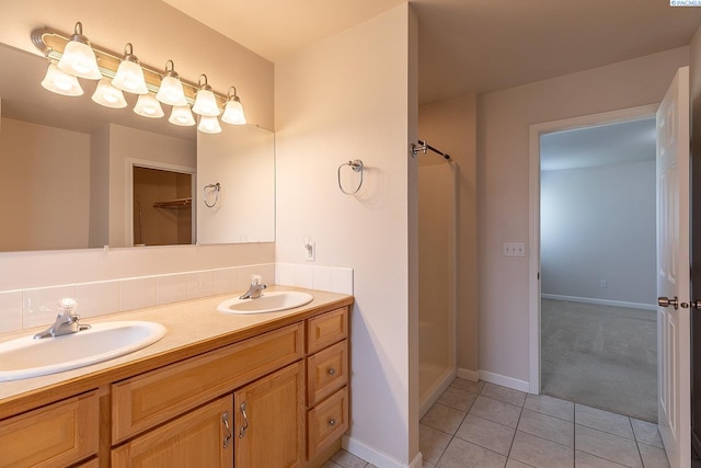 1506 SW Capri Ct, Pullman, WA 99163 - bathroom with a stall shower, tile patterned flooring, double vanity, and baseboards