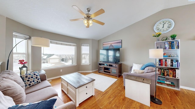 living room with lofted ceiling, light hardwood / wood-style floors, and ceiling fan