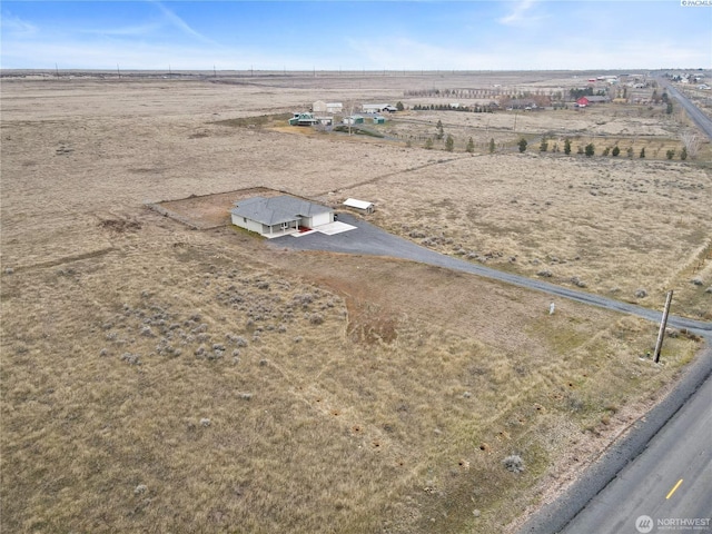 birds eye view of property with a rural view