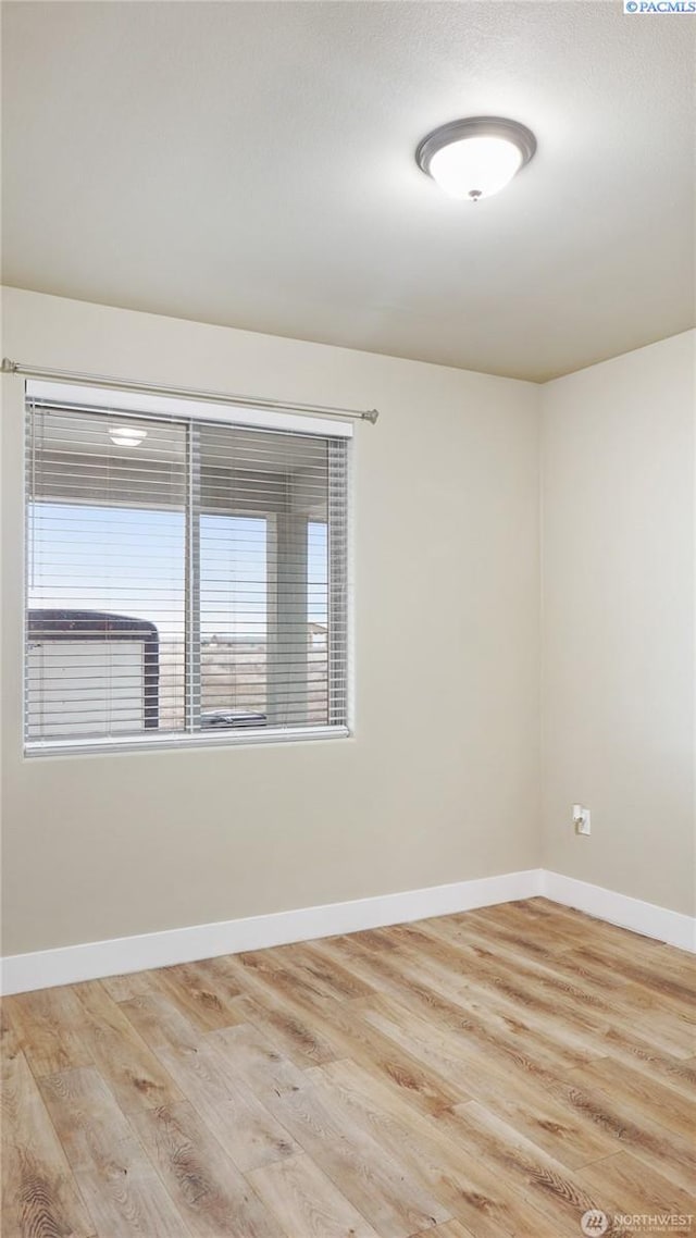 empty room with light hardwood / wood-style flooring