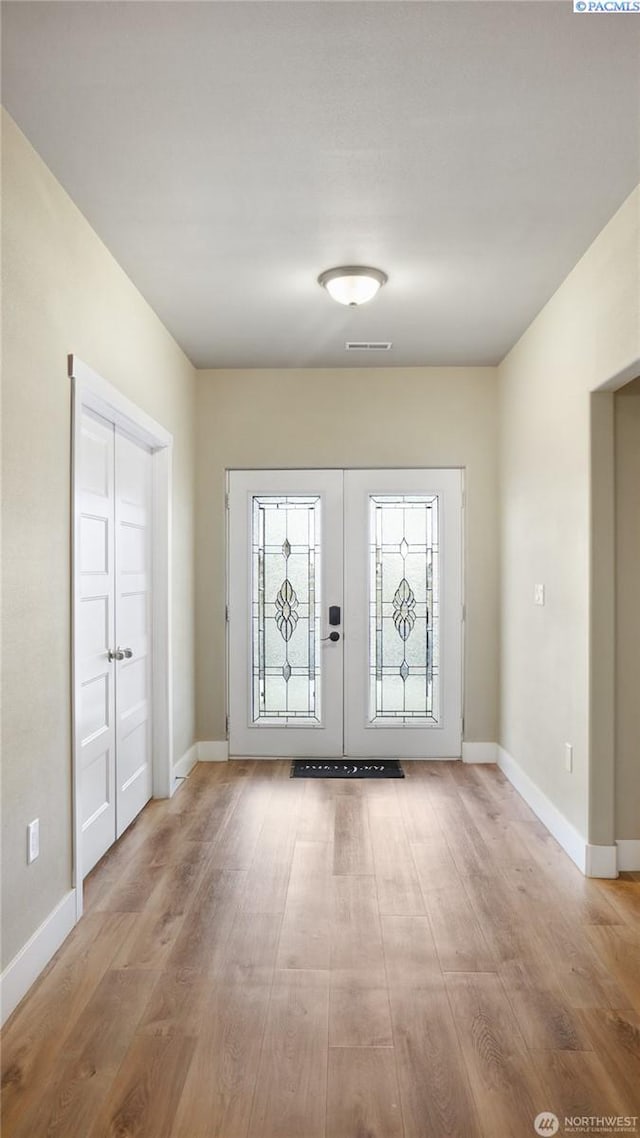 entrance foyer with french doors and light wood-type flooring