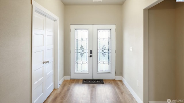 foyer featuring light hardwood / wood-style floors and french doors