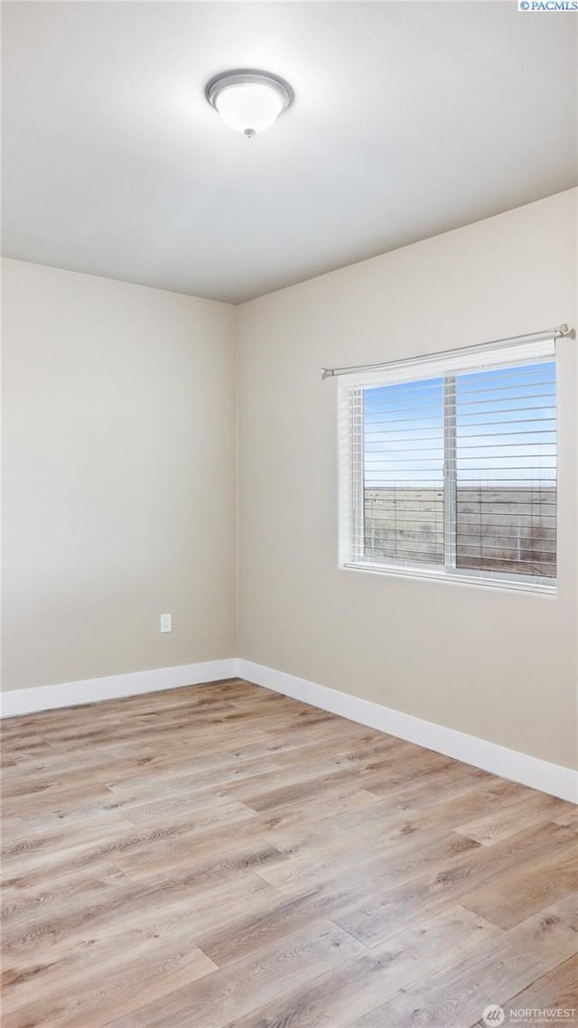 unfurnished room with light hardwood / wood-style flooring