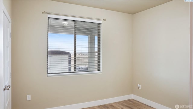 unfurnished room with light wood-type flooring