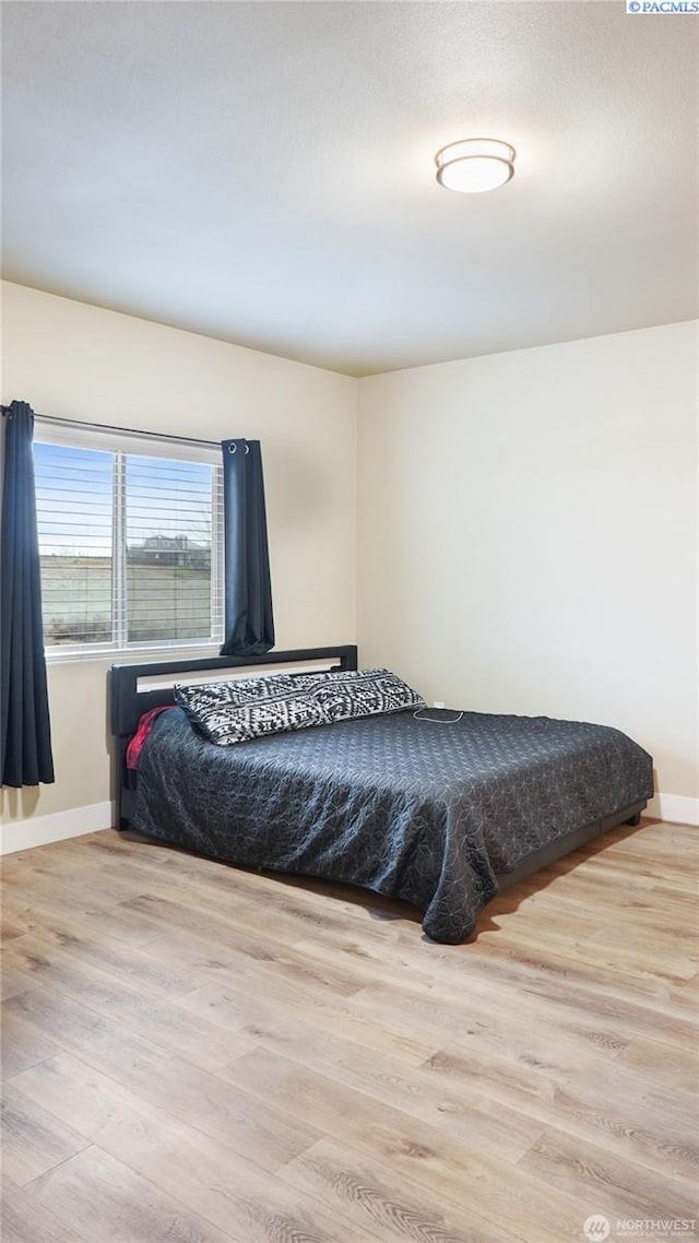 bedroom with light hardwood / wood-style floors