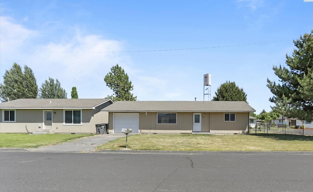 ranch-style house with a garage and a front yard