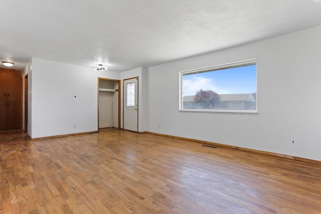 spare room with light hardwood / wood-style floors