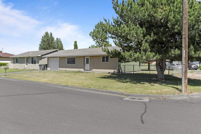 single story home featuring a garage and a front yard