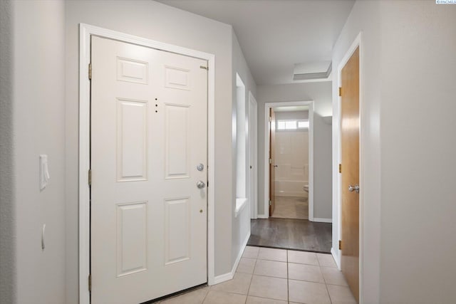 entrance foyer featuring baseboards and light tile patterned flooring