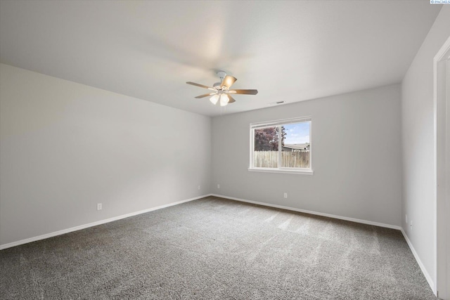 carpeted empty room with baseboards and a ceiling fan