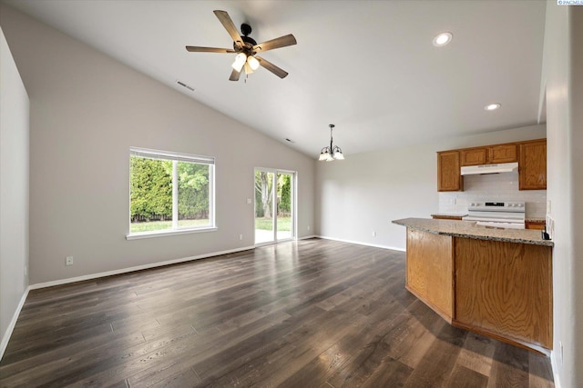 kitchen featuring brown cabinets, electric stove, open floor plan, under cabinet range hood, and visible vents