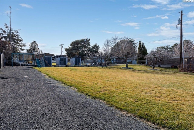 view of road featuring driveway and a gated entry