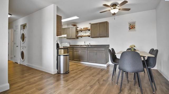 1645 NE Merman Dr Unit B101, Pullman, WA 99163 - kitchen with stacked washer / drying machine, ceiling fan, open shelves, wood finished floors, and dark countertops