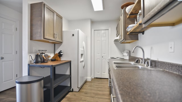 1645 NE Merman Dr Unit B101, Pullman, WA 99163 - kitchen featuring light wood finished floors, white refrigerator with ice dispenser, dark countertops, and range