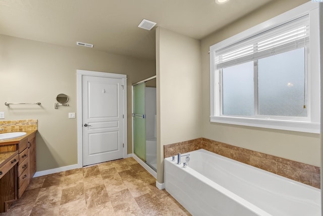 3203 Cavalier Ct, Pasco, WA 99301 - bathroom featuring vanity, baseboards, a shower stall, and a garden tub