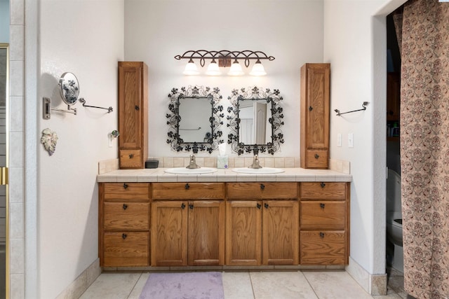 bathroom featuring tile patterned flooring, vanity, and toilet