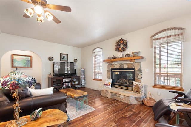 living room with ceiling fan, wood-type flooring, and a fireplace