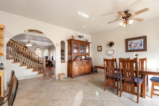 dining area with ceiling fan and light tile patterned flooring