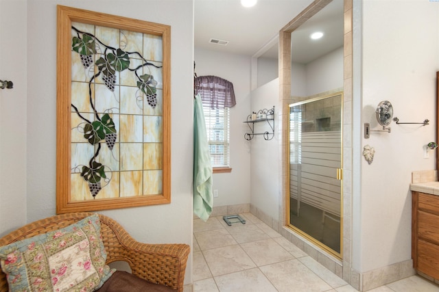 bathroom with vanity, tile patterned floors, and a shower with door