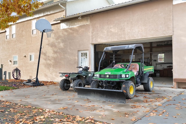 exterior space featuring central AC unit and a garage