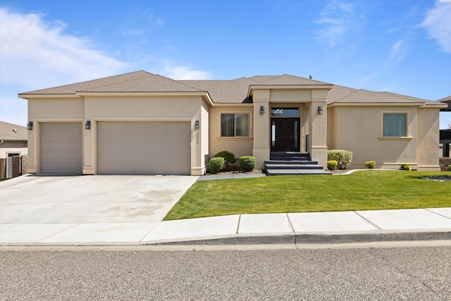 prairie-style house featuring a garage and a front yard