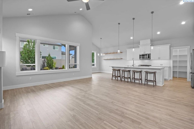 3149 Wild Canyon Way, Richland, WA 99354 - living area with a ceiling fan, high vaulted ceiling, light wood finished floors, baseboards, and recessed lighting