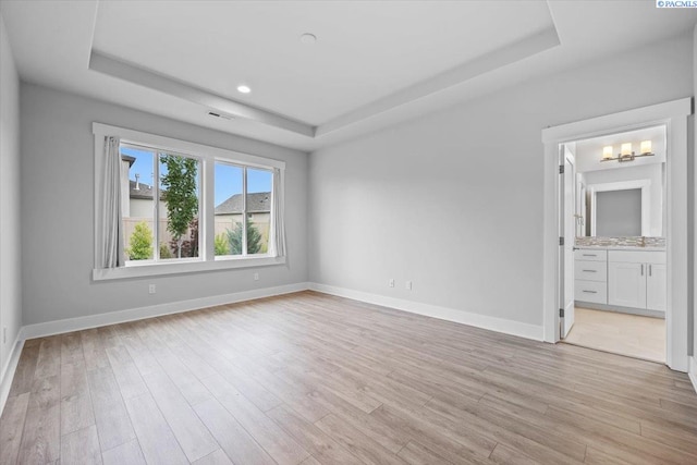 3149 Wild Canyon Way, Richland, WA 99354 - spare room featuring a raised ceiling, light wood-type flooring, baseboards, and recessed lighting