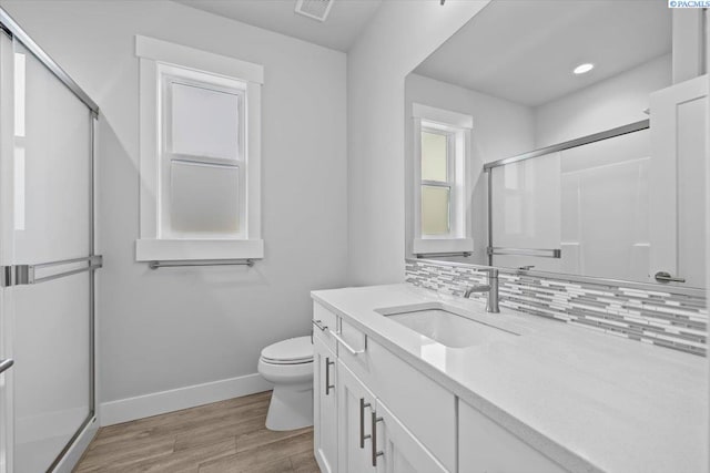 3149 Wild Canyon Way, Richland, WA 99354 - full bath with wood finished floors, a shower stall, vanity, baseboards, and toilet
