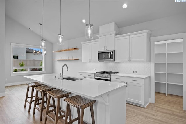 3149 Wild Canyon Way, Richland, WA 99354 - kitchen with stainless steel appliances, a sink, tasteful backsplash, open shelves, and a breakfast bar area