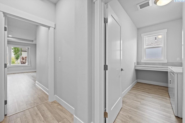 3149 Wild Canyon Way, Richland, WA 99354 - hallway featuring independent washer and dryer, light wood-style flooring, and baseboards