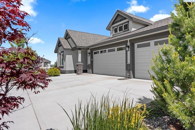 3149 Wild Canyon Way, Richland, WA 99354 - view of property exterior with stucco siding, stone siding, a shingled roof, and concrete driveway