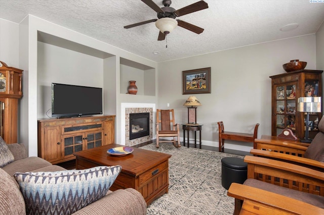 living room with ceiling fan and a textured ceiling