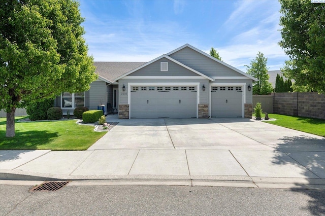 craftsman inspired home with a garage and a front yard