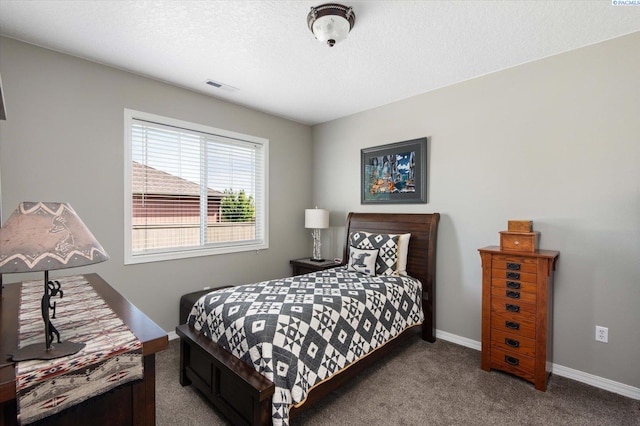 carpeted bedroom with a textured ceiling