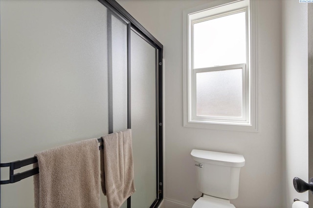 bathroom with walk in shower and toilet