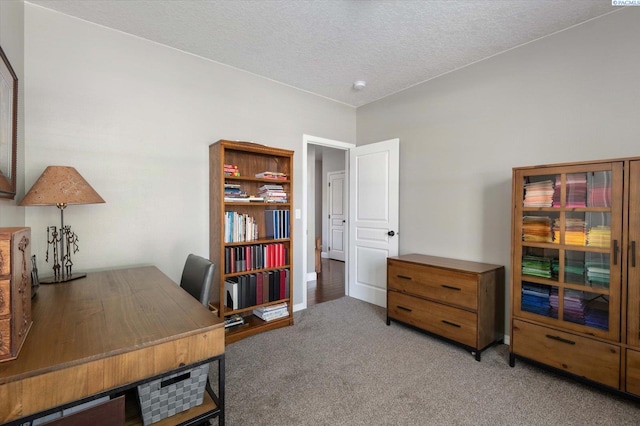 home office with carpet floors and a textured ceiling