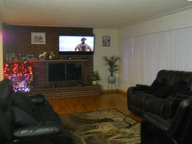 619 Grandview Ave, Sunnyside, WA 98944 - living room with wood finished floors, a brick fireplace, and baseboards