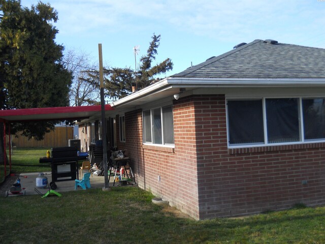 619 Grandview Ave, Sunnyside, WA 98944 - view of home's exterior with a lawn and brick siding