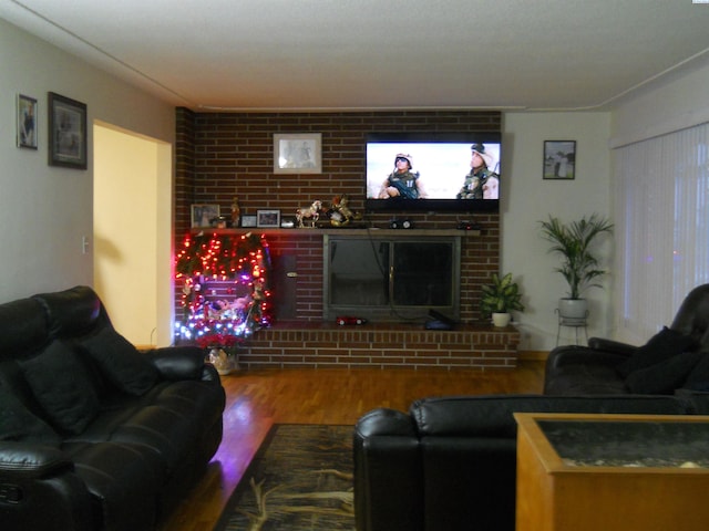 619 Grandview Ave, Sunnyside, WA 98944 - living room featuring a fireplace, wood finished floors, and brick wall