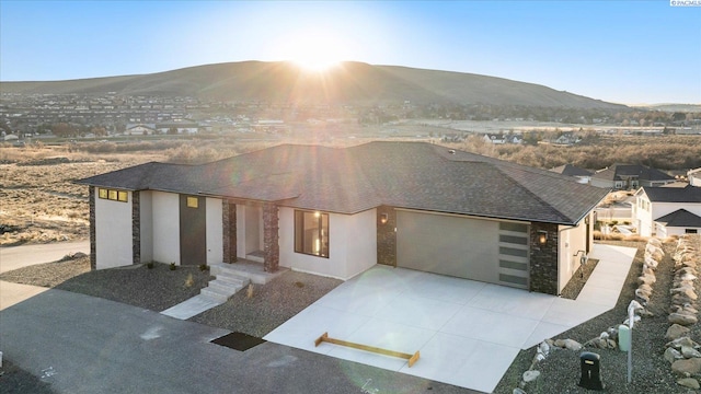 view of front of house featuring a mountain view and a garage