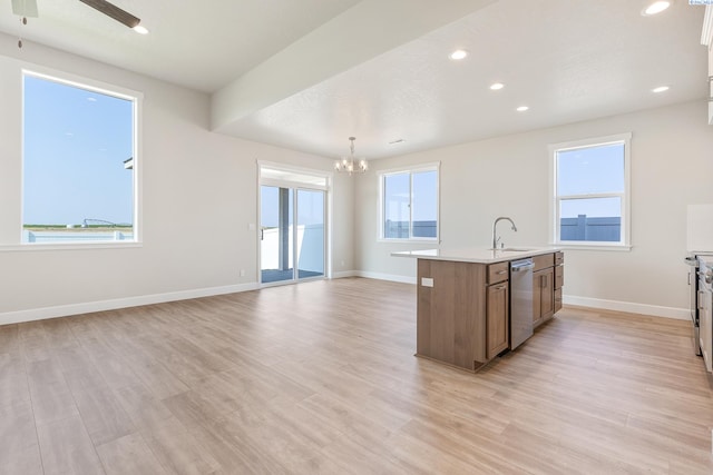 8801 Dusty Maiden Dr, Pasco, WA 99301 - kitchen with stainless steel dishwasher, a chandelier, an island with sink, light wood-style floors, and ceiling fan