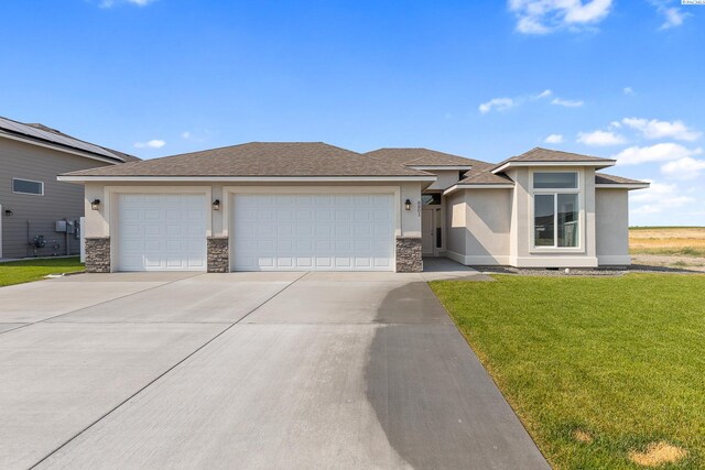 8801 Dusty Maiden Dr, Pasco, WA 99301 - view of front of home featuring concrete driveway, an attached garage, stucco siding, a front lawn, and stone siding