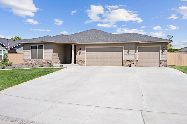 prairie-style home featuring a garage and a front yard