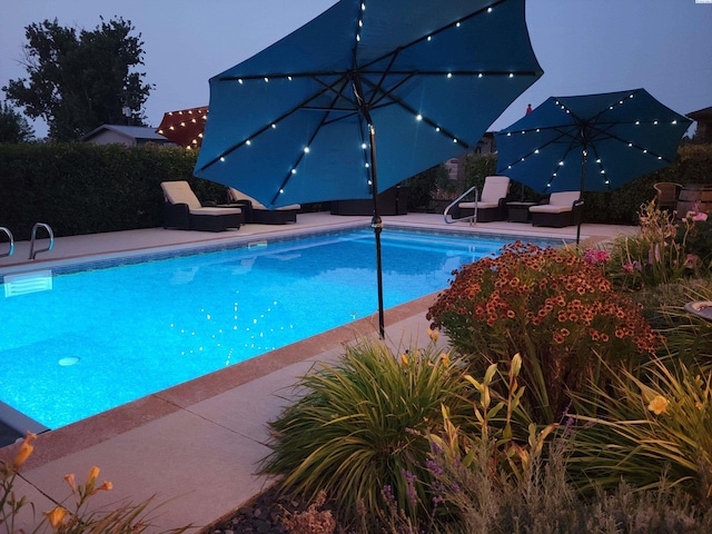 view of swimming pool featuring a fenced in pool and a patio