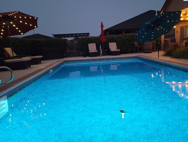 view of swimming pool featuring a patio area and a fenced in pool