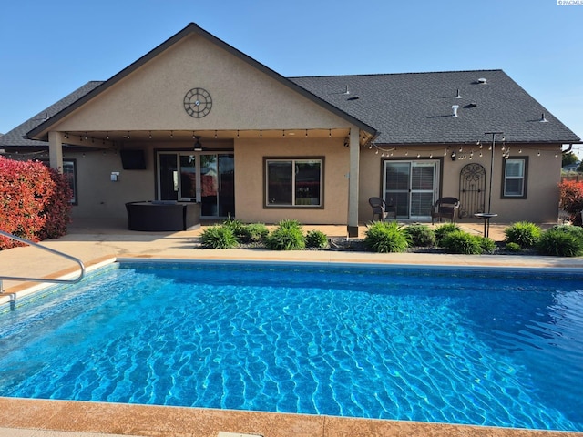 7813 Agate Ct, Pasco, WA 99301 - back of property with a ceiling fan, an outdoor pool, a shingled roof, stucco siding, and a patio area